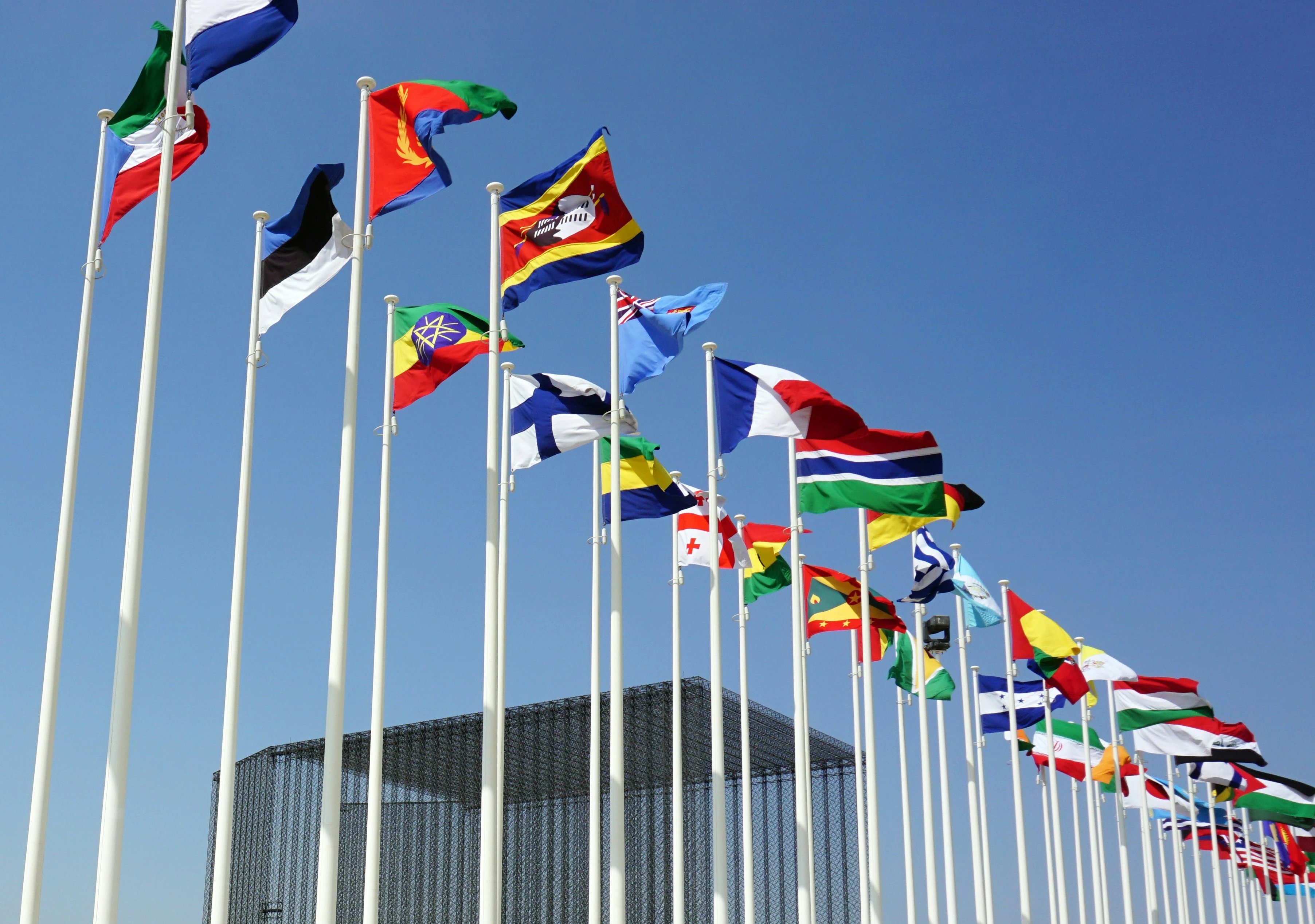International flags display representing diverse global recruitment destinations.