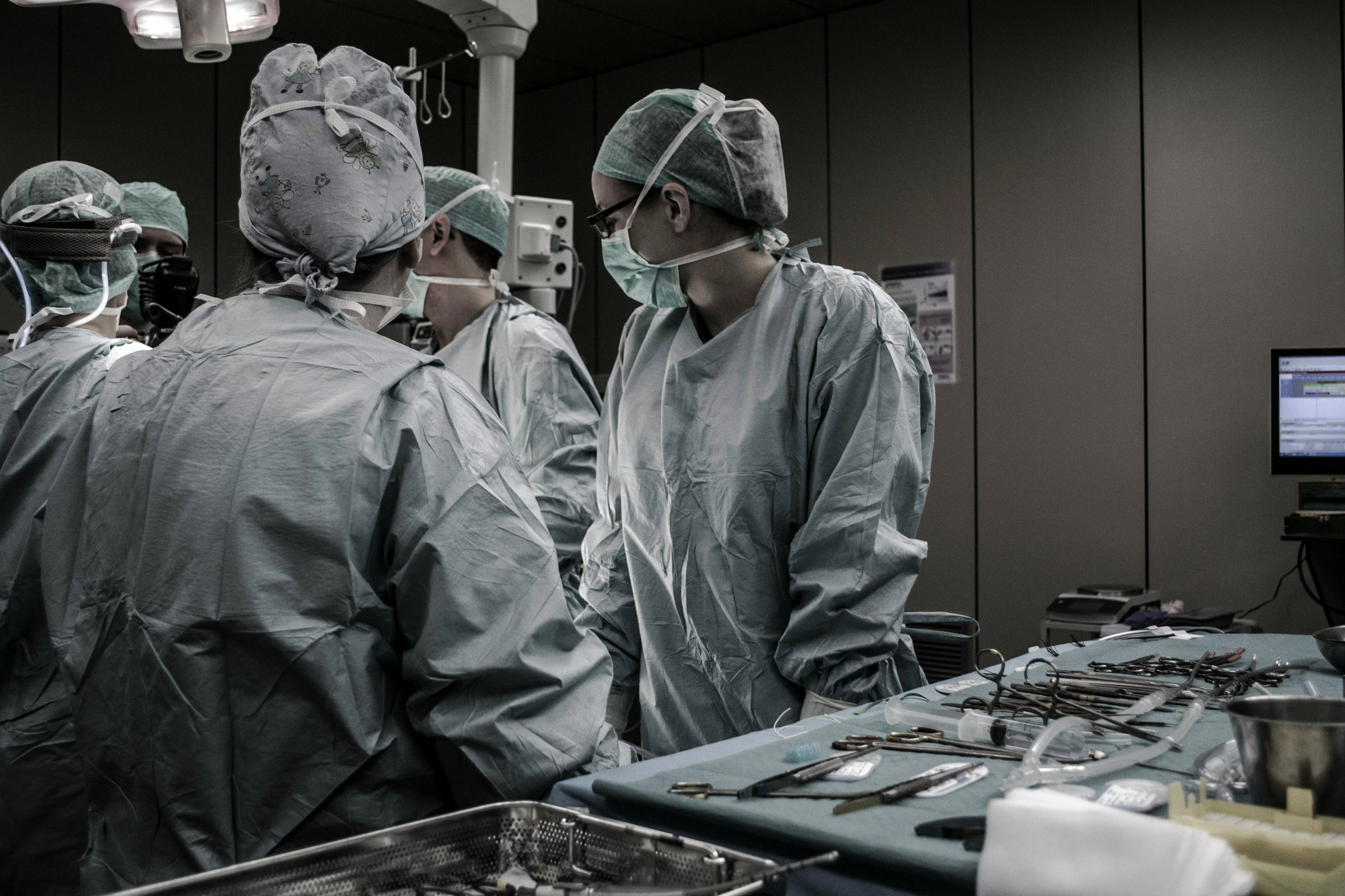Surgical healthcare team performing a procedure in a modern operating room.
