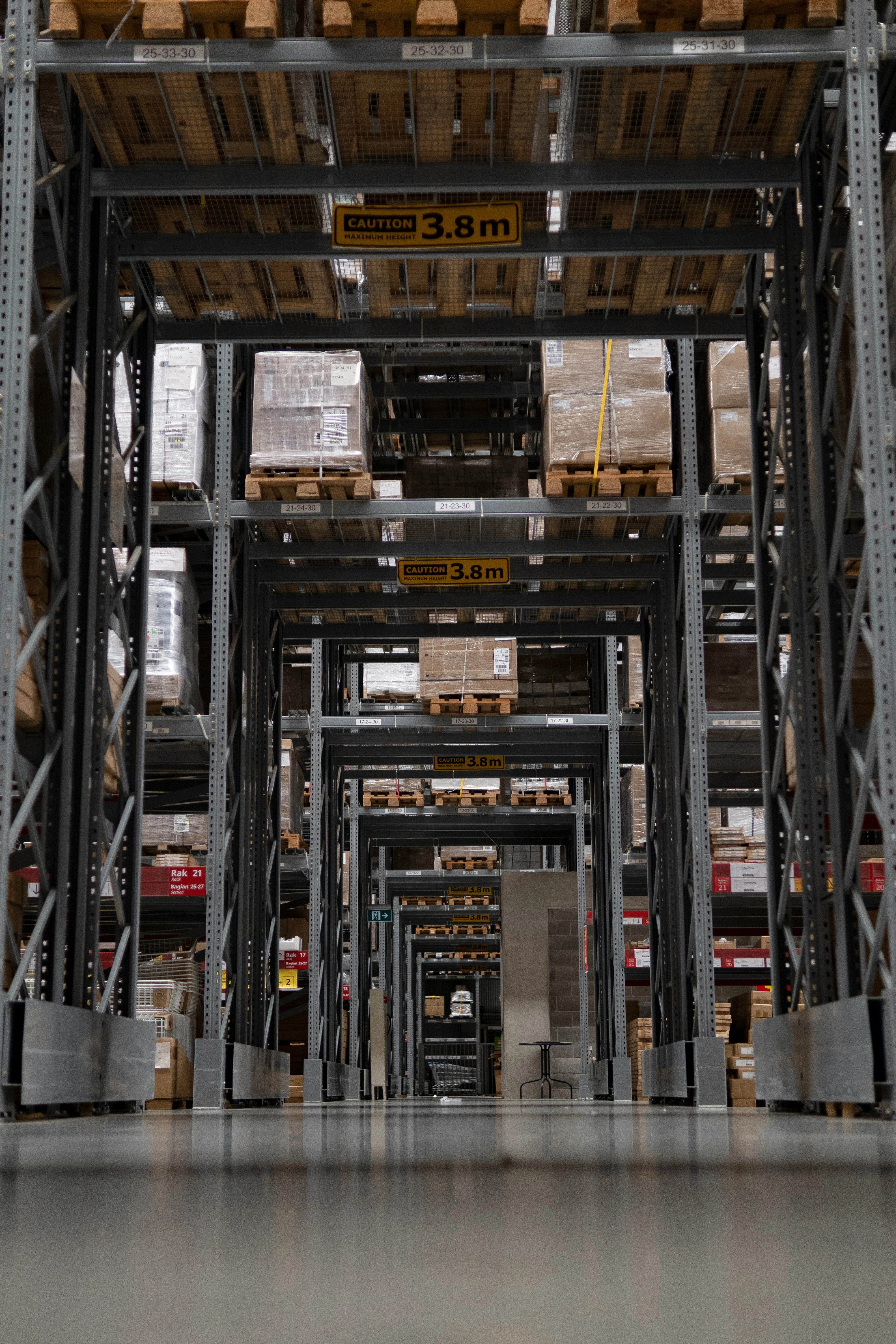Warehouse aisle with organized inventory shelves representing supply chain operations.