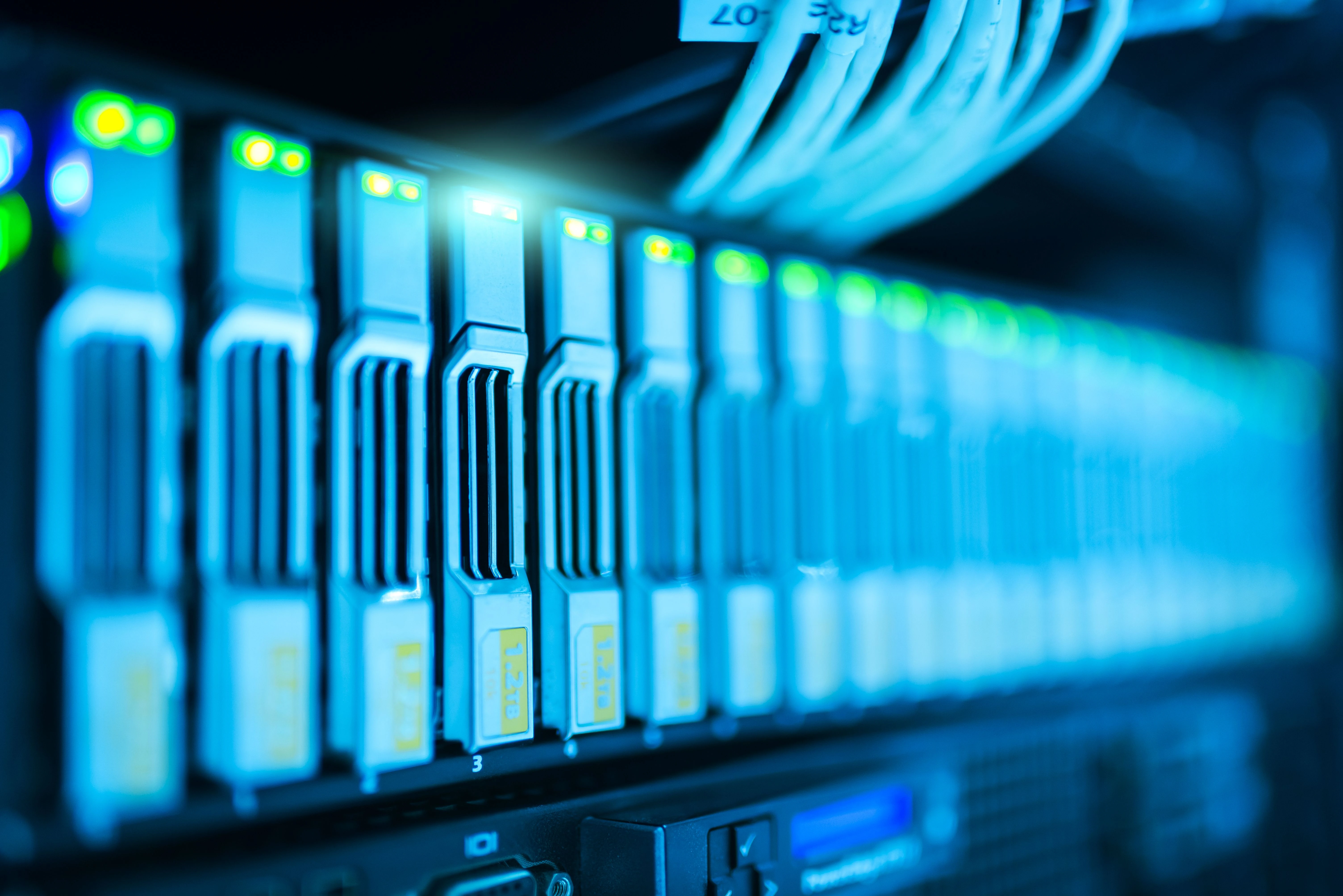 Server racks in a data center with illuminated network lights representing IT infrastructure recruitment.